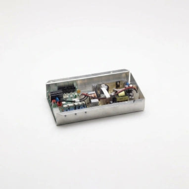 A small rectangular metal electronic control box with its lid open, showing internal circuitry, capacitors, and wires, set against a plain white background.