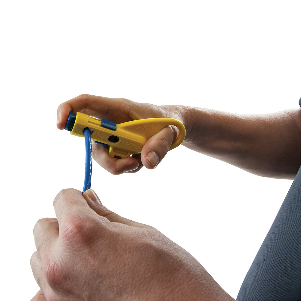 Person using a yellow cable tie gun on a white background