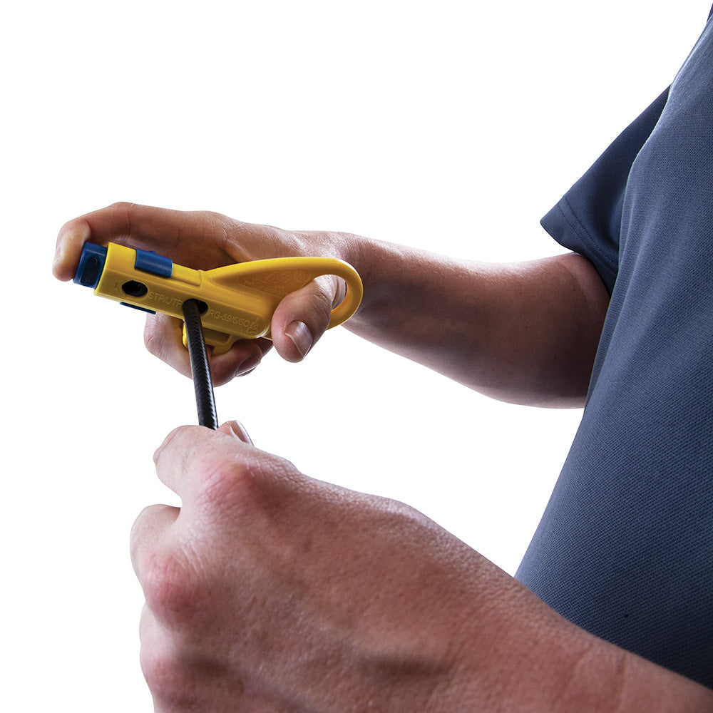 Person using a yellow tool with a black handle on a white background