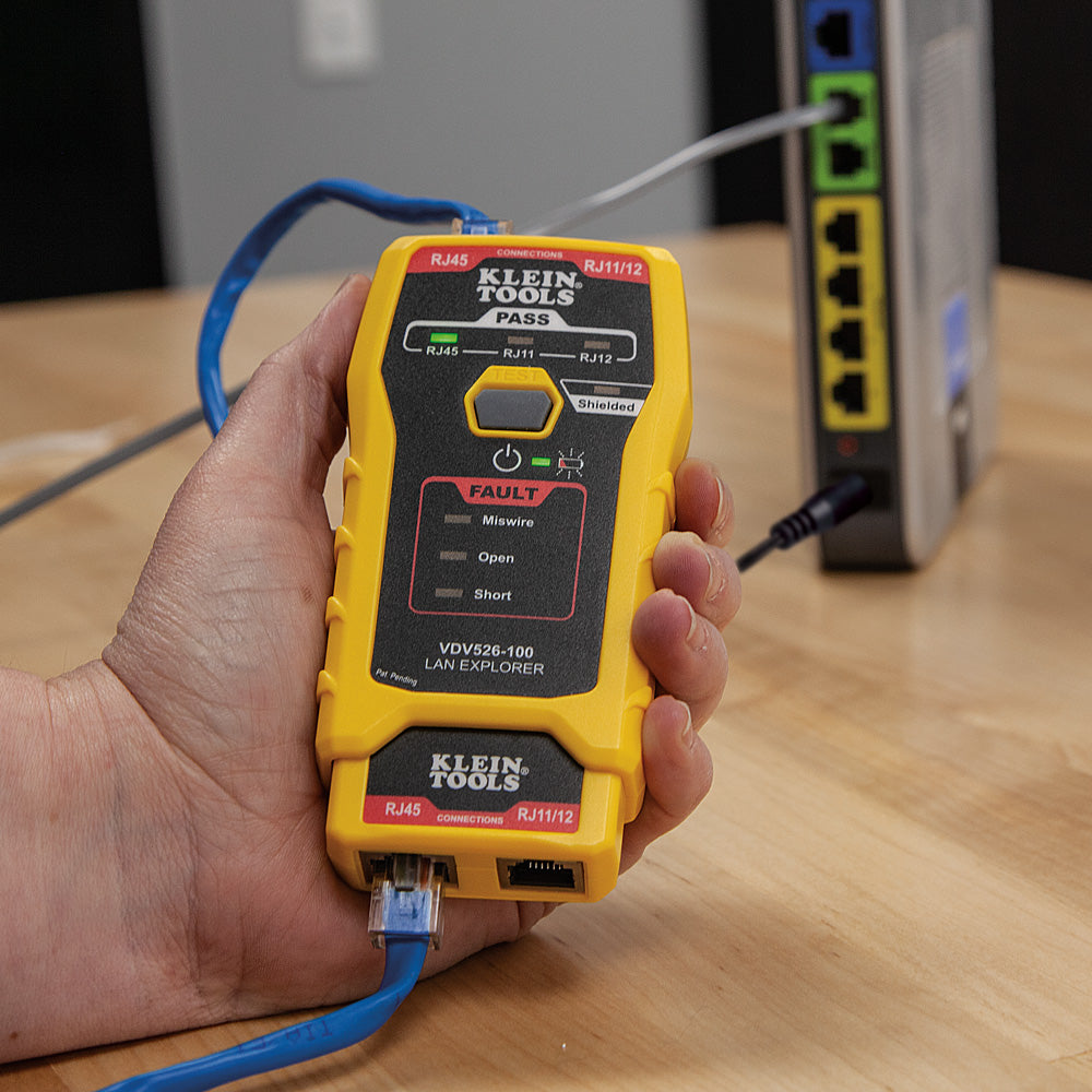 Klein Tools LAN Explorer cable tester being used on a network device.